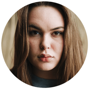 Close-up portrait of a serious young woman with long hair.