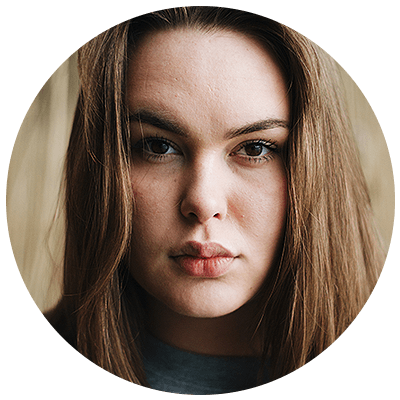 Close-up portrait of a serious young woman with long hair.