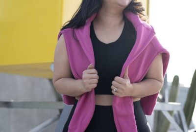 Smiling woman in workout clothes by lifeguard tower