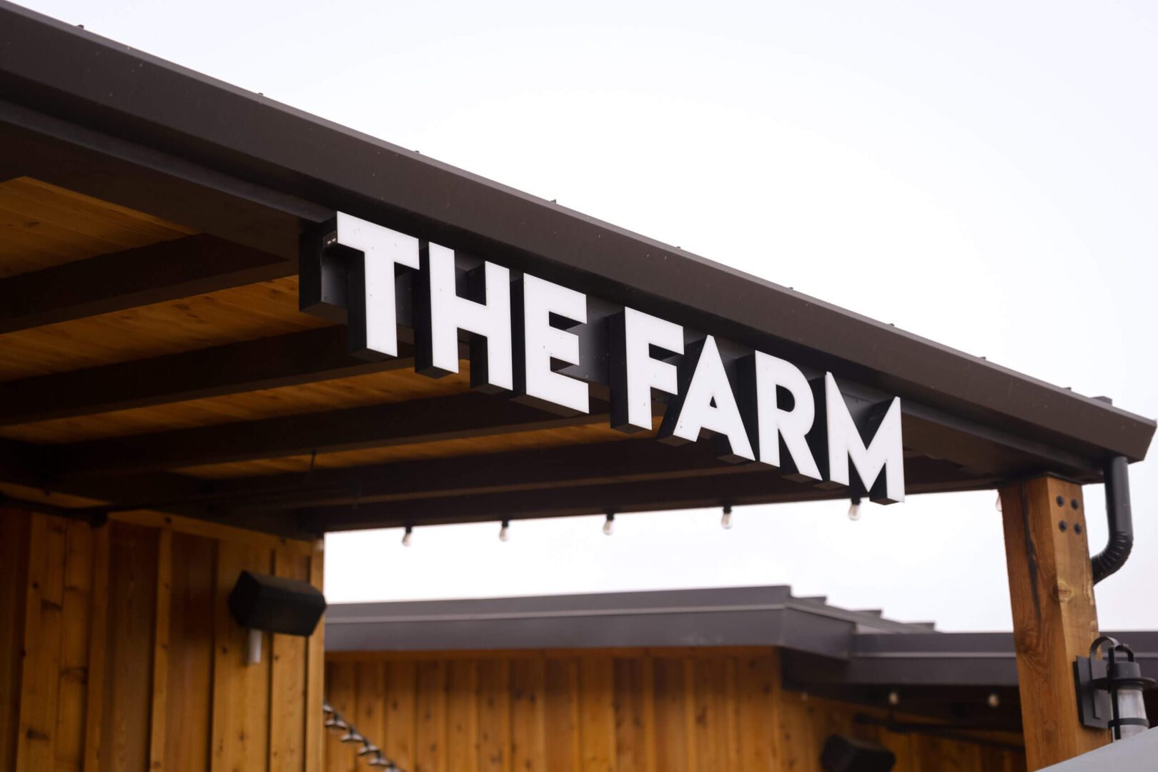 Wooden awning displaying bold THE FARM sign