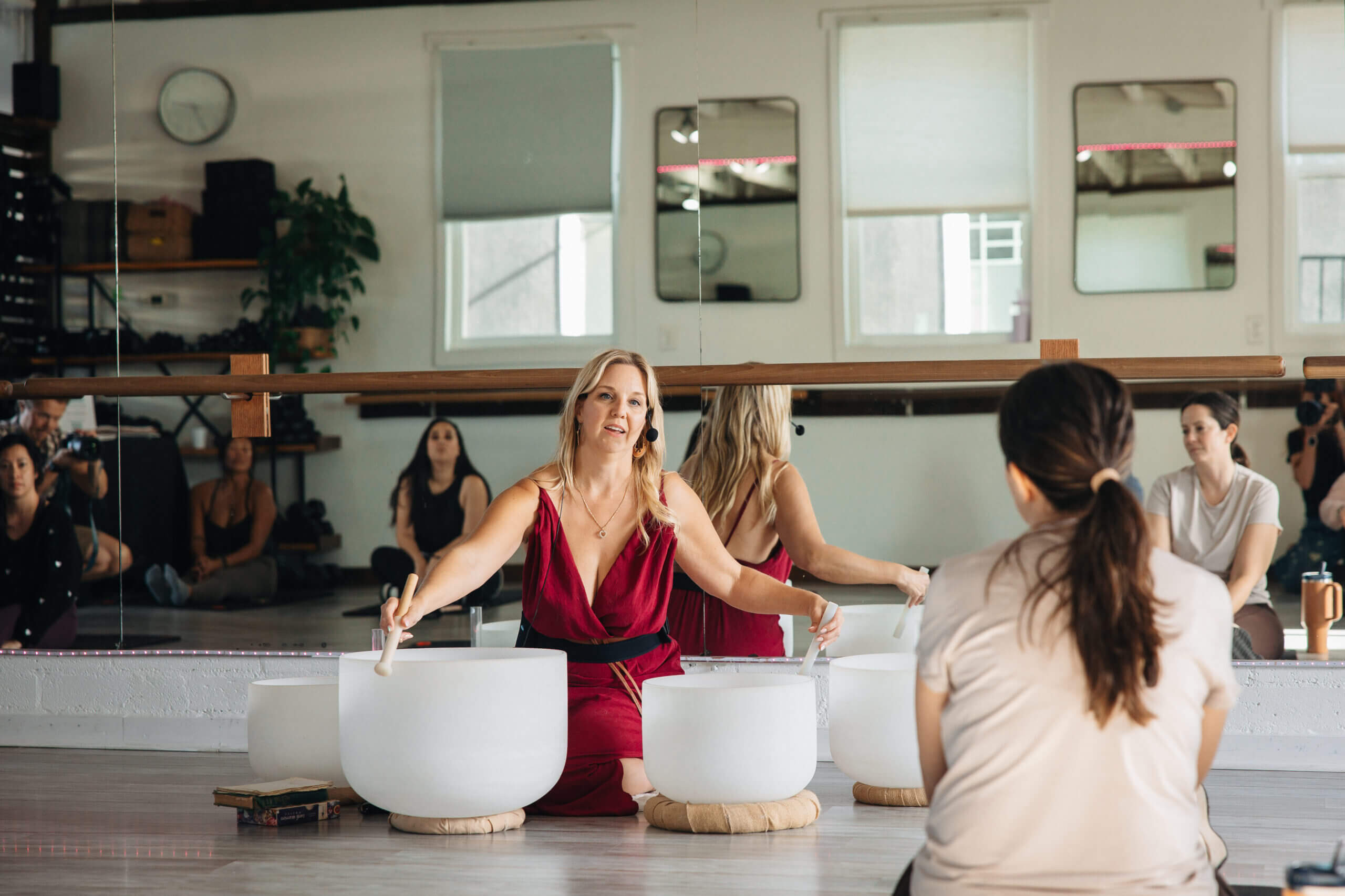 Facilitator striking bowls for group meditation