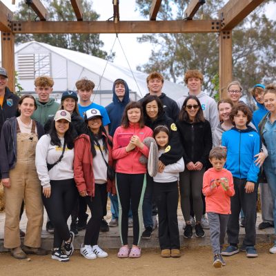 Community volunteers gathered in greenhouse garden