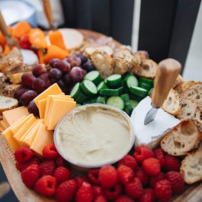 Fresh raspberries encircling dip on serving board