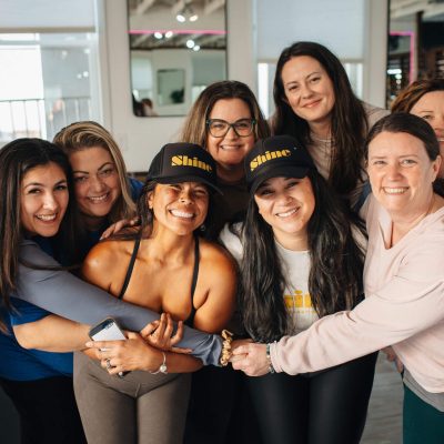 Group of women smiling and hugging closely
