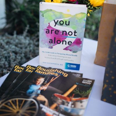 Book titled you are not alone with sunflowers